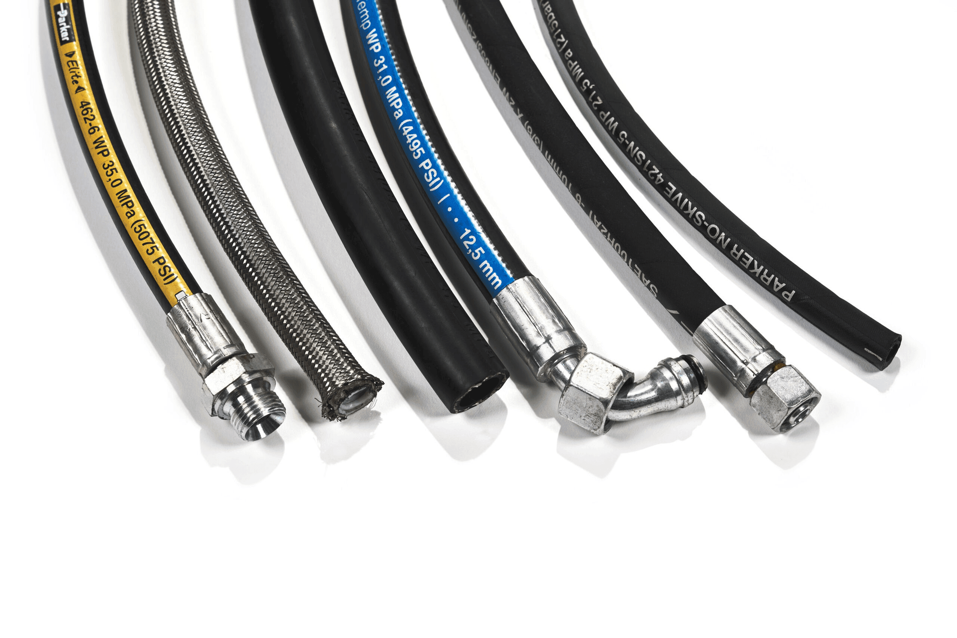 Various hydraulic hoses with different fittings and coverings laid out on a white background.